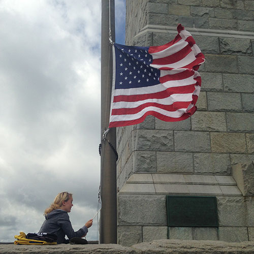 monument and woman with flag