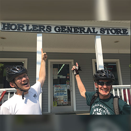 two riders pointing at sign in unionville